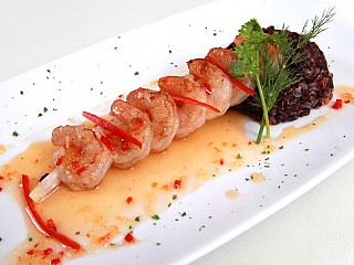 Pan fried shrimps on lemongrass skewer served