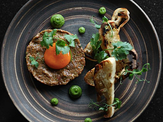 Steak tartare marinated with ginger chili, spring onion & coriander puree, garlic crouton, organic egg yolk